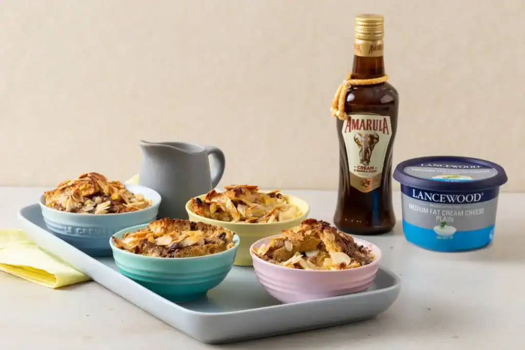 The Ultimate Heritage Day Food Guide: Indulgent Amarula and cream cheese bread & butter pudding served in bowls – festive South African dessert recipes