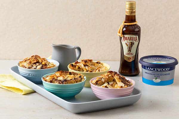 The Ultimate Heritage Day Food Guide: Indulgent Amarula and cream cheese bread & butter pudding served in bowls – festive South African dessert recipes