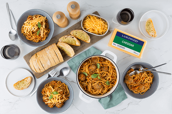 Celebrate World Pasta Day with these 10 irresistible recipes Delicious spaghetti and cheese-topped meatballs recipe South Africa with Lancewood Cheddar and garlic bread.