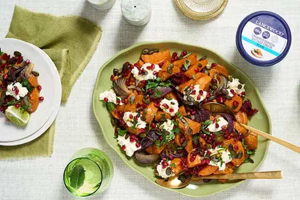 Delicious Recipes to Celebrate the Festive Season Together Festive roasted Sweet Potato Salad topped with LANCEWOOD® Cottage Cheese, pumpkin seeds, and cranberries - a protein-rich cottage cheese recipe perfect for the holidays.