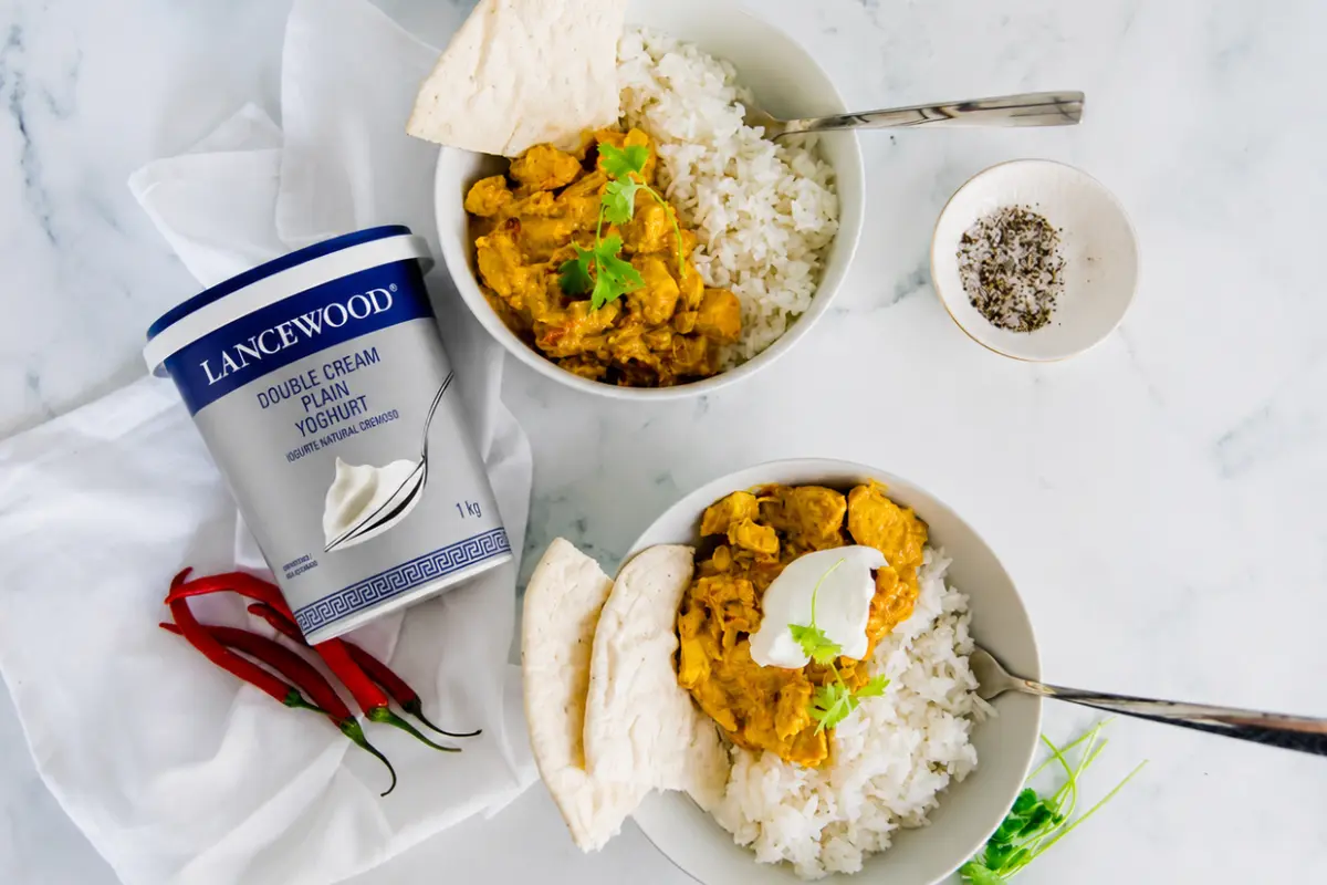 Creamy chicken curry served with fluffy white rice, naan bread and Lancewood Double Cream Plain Yoghurt