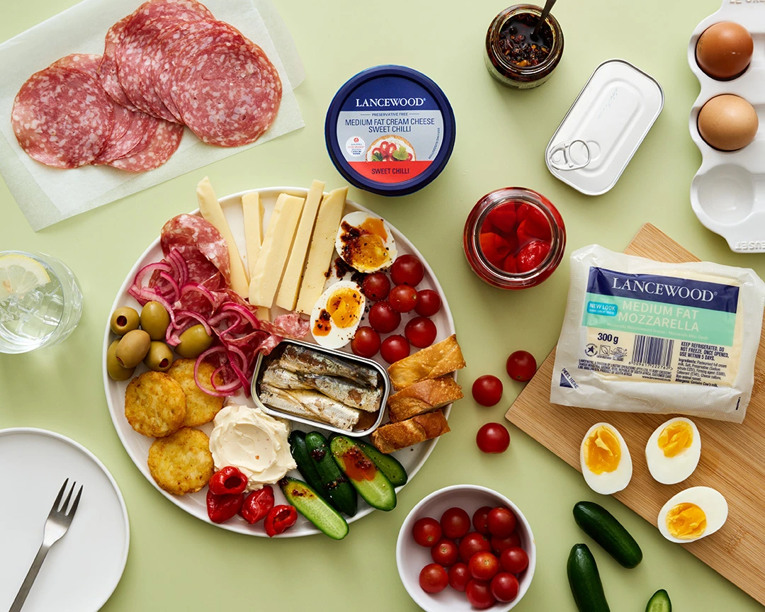 South African savoury snack plate with cheese, cured meat, hash browns, cucumbers and tomatoes